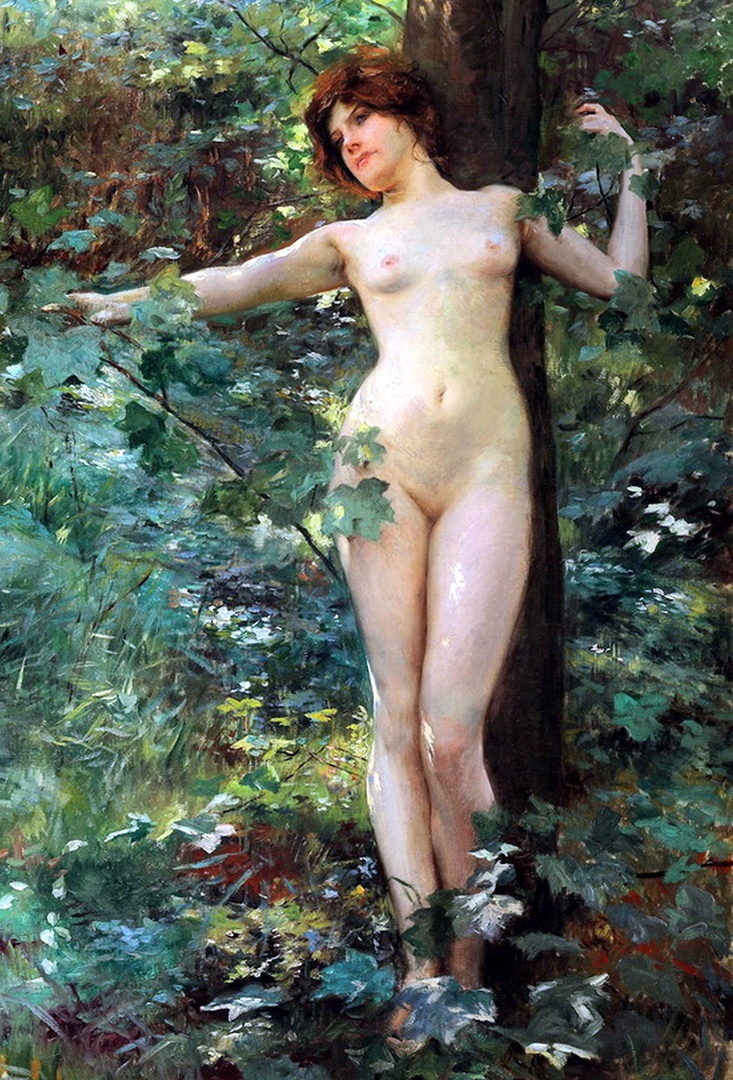 A sexy naked girl in the bush with nice breasts. The rauncy young woman is leaning against a tree. She has a shaved pussy and nice eyes.